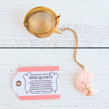 Gold color tea ball infuser for loose leaf tea with moon shaped rose quartz gemstone crystal wire wrapped with gold wire into tree of life design - includes tag with association and properties of the stone