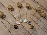 Gold Wire-Wrapped Teardrop Gemstone Tea Ball Infuser - Golden colored tea ball with gold wire wrapped tree on crystal stone tear pendant