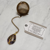 Gold Wire-Wrapped Teardrop Gemstone Tea Ball Infuser - Golden colored tea ball with gold wire wrapped tree on crystal stone tear pendant