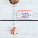 Rose gold copper color tea ball infuser for loose leaf tea with moon shaped rose quartz gemstone crystal wire wrapped with copper wire into tree of life design - includes tag with association and properties of the stone