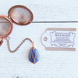 Handmade rose gold copper color tea ball infuser for loose leaf tea with teardrop shaped blue agate gemstone crystal wire wrapped with copper wire into tree of life design - includes tag with associations and properties of the stone