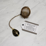 Gold Wire-Wrapped Teardrop Gemstone Tea Ball Infuser - Golden colored tea ball with gold wire wrapped tree on crystal stone tear pendant